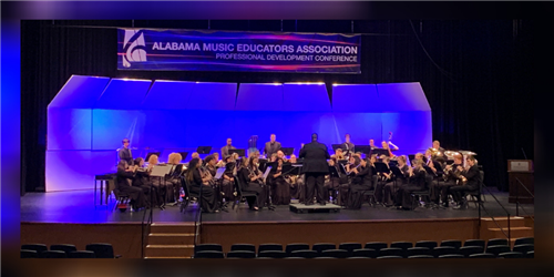 wind ensemble on stage at a performance 